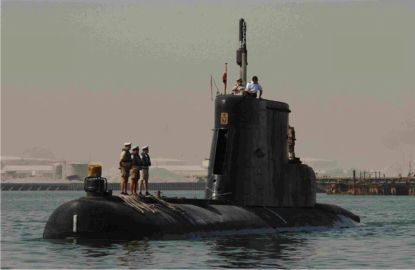 A group of people standing on a submarine in the water Description automatically generated with medium confidence